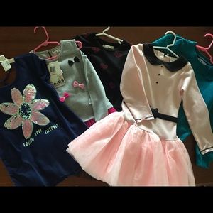 Lot of girls clothes.  Dresses, shirt, sweater
